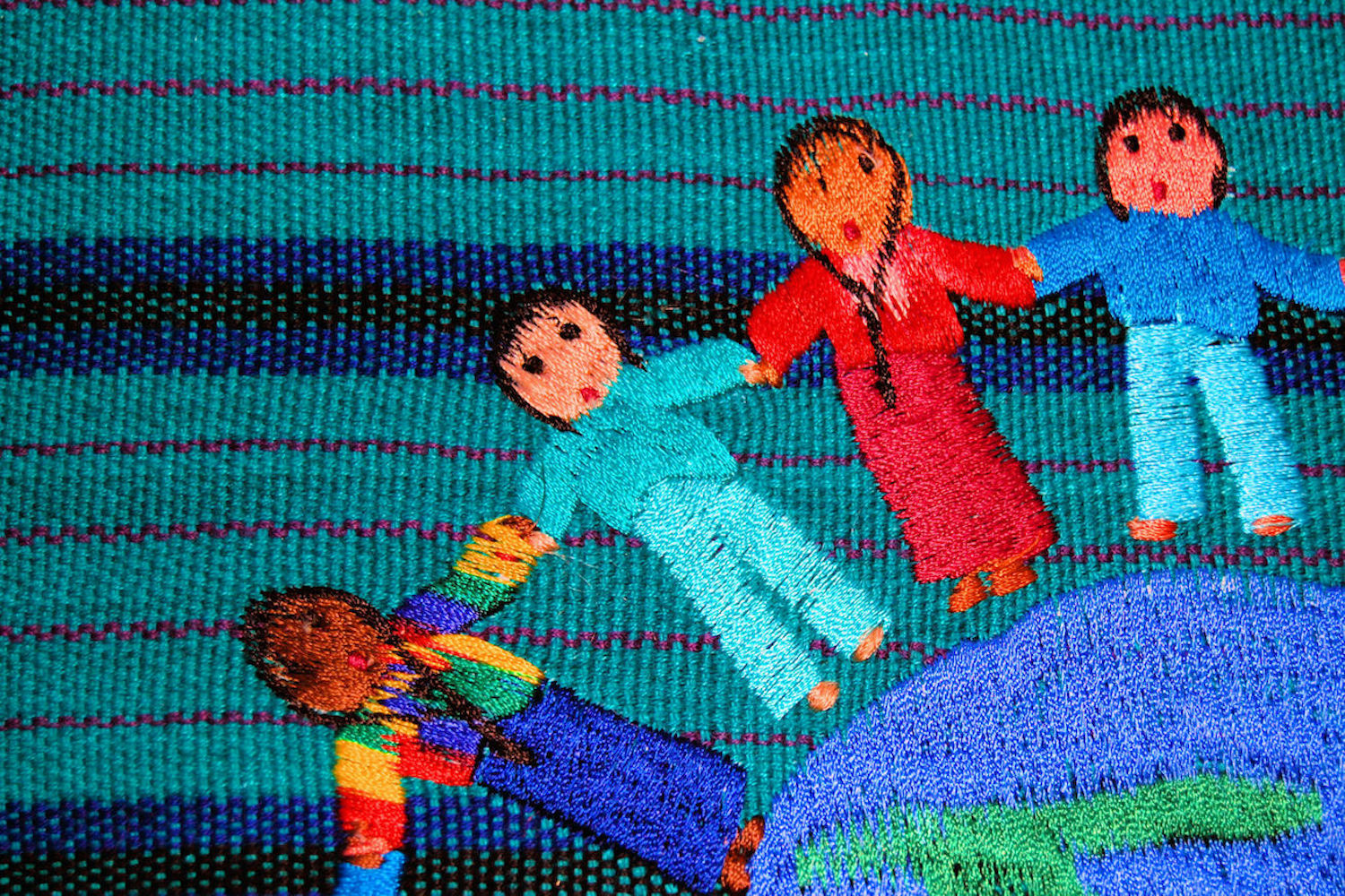 An embroidery of people holding hands